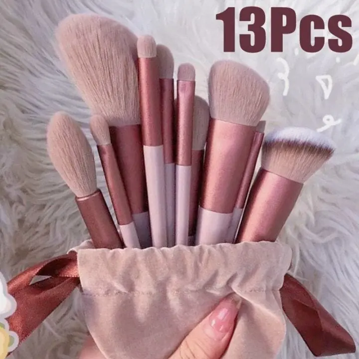 Pink thirteen piece makeup brush set displayed inside pouch