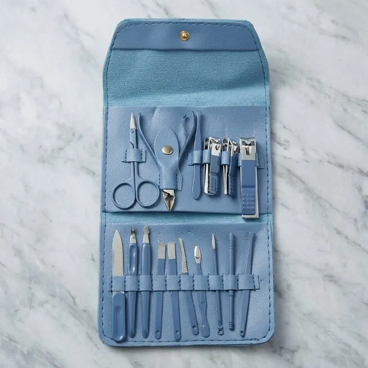 Open manicure pedicure kit showing sixteen manual grooming tools