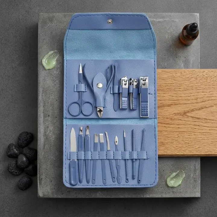 Manual nail grooming tools secured inside a blue travel case
